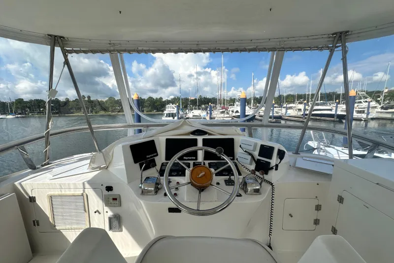 Slide: The Image of Cockpit view of 2001 Prima 52 Seahorse yacht, featuring steering wheel and navigation equipment. - 83