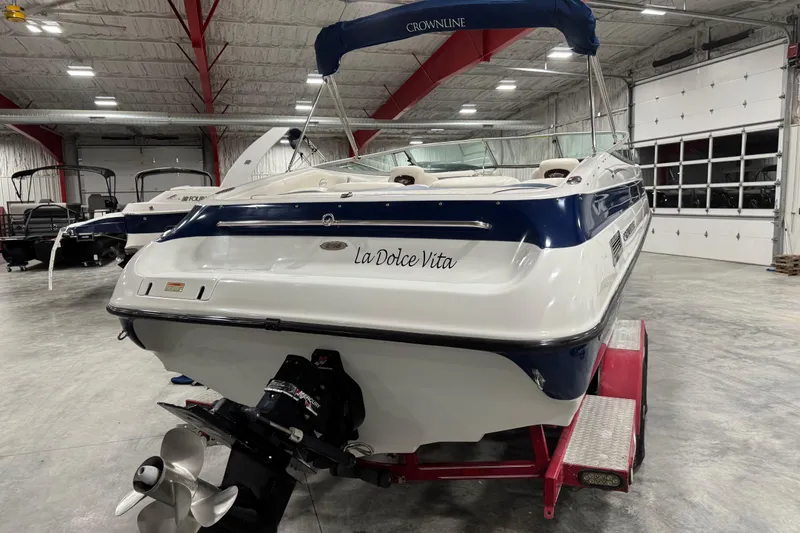Slide: The Image of 2004 Crownline 266 BR boat in a garage, featuring "La Dolce Vita" on the stern. - 5