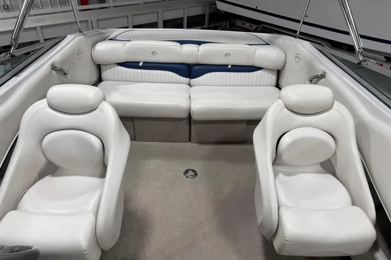 Slide: The Image of 2004 Crownline 266 BR boat interior with white leather seating and modern design. - 7