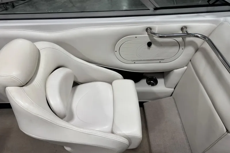 Slide: The Image of White interior seating of 2004 Crownline 266 BR boat, featuring sleek design and comfortable upholstery. - 8