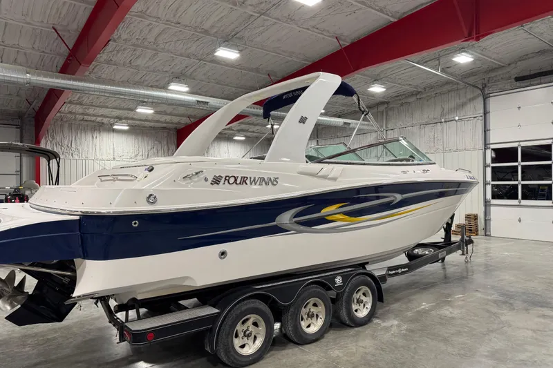 Slide: The Image of 2005 Four Winns 290 Horizon boat on trailer in indoor storage facility. - 4