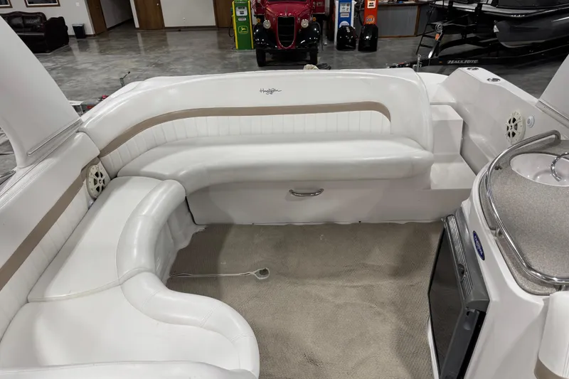 Slide: The Image of 2005 Four Winns 290 Horizon boat interior with white seating and kitchenette. - 6