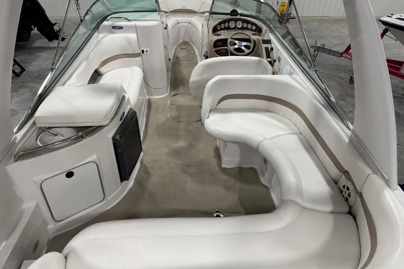 Slide: The Image of 2005 Four Winns 290 Horizon boat interior with white seating and dashboard. - 9