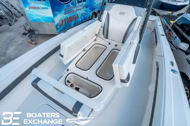 Slide: The Image of 2023 ShearWater 270 SS Carolina boat with storage and seating area. - 18
