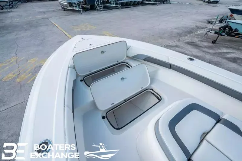 Slide: The Image of 2023 ShearWater 270 SS Carolina with open storage compartments at the dock. - 19
