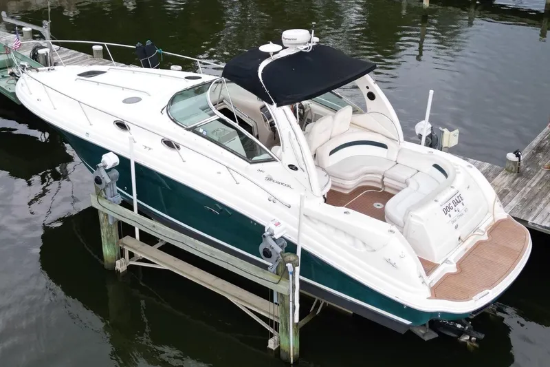 The Image of 2005 Sea Ray 340 Sundancer boat docked, featuring sleek design and spacious seating. - 0