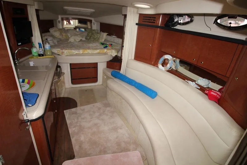 Slide: The Image of Interior of 2005 Sea Ray 340 Sundancer yacht with cozy seating and kitchenette. - 13