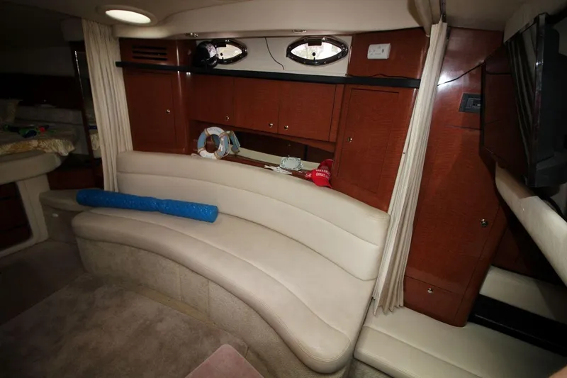 Slide: The Image of Interior of 2005 Sea Ray 340 Sundancer with curved seating and wooden cabinetry. - 14