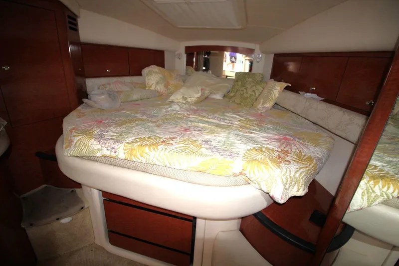 Slide: The Image of 2005 Sea Ray 340 Sundancer cabin with cozy bed and floral bedding. - 16