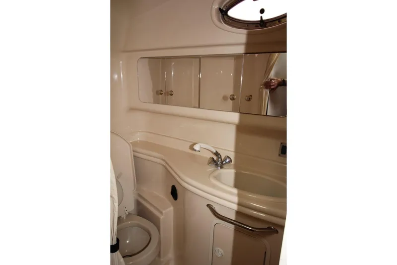Slide: The Image of 2005 Sea Ray 340 Sundancer bathroom with sink, mirror, and toilet. - 18