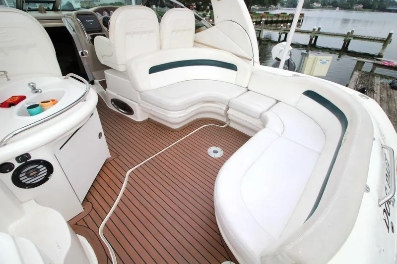 Slide: The Image of 2005 Sea Ray 340 Sundancer boat interior with white seating and wood flooring. - 8