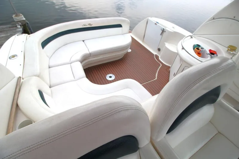Slide: The Image of Luxurious 2005 Sea Ray 340 Sundancer boat interior with white seating and wood flooring. - 9