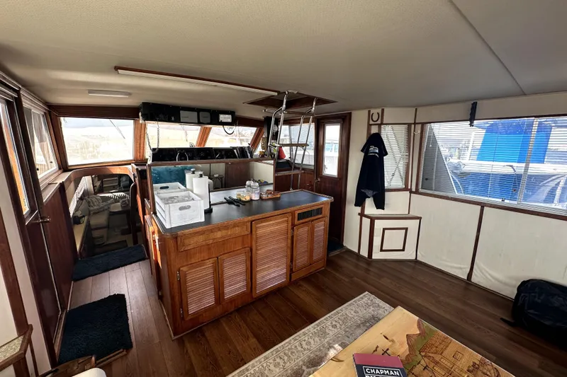 Slide: The Image of 1985 Chris-Craft 500 Constellation yacht interior with wood finishes and spacious layout. - 10