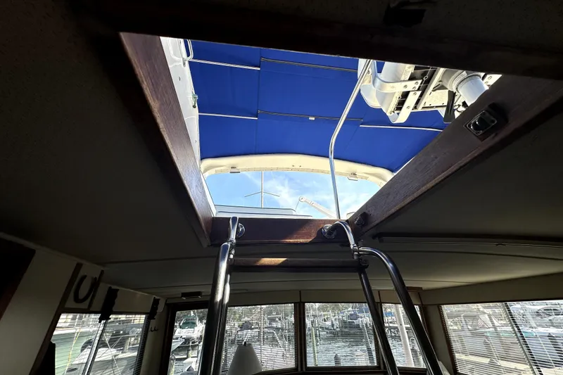 Slide: The Image of Interior view of 1985 Chris-Craft 500 Constellation yacht with open hatch and blue canopy. - 103