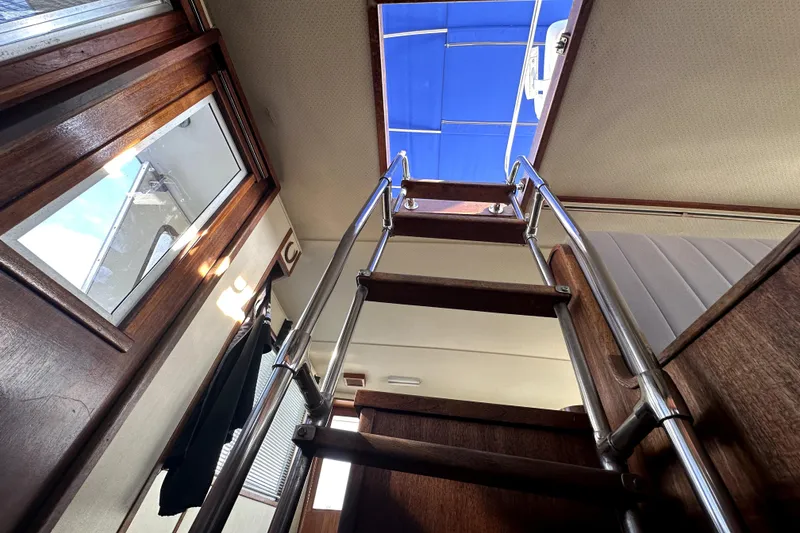 Slide: The Image of Interior view of 1985 Chris-Craft 500 Constellation yacht with wooden ladder and blue canopy. - 105