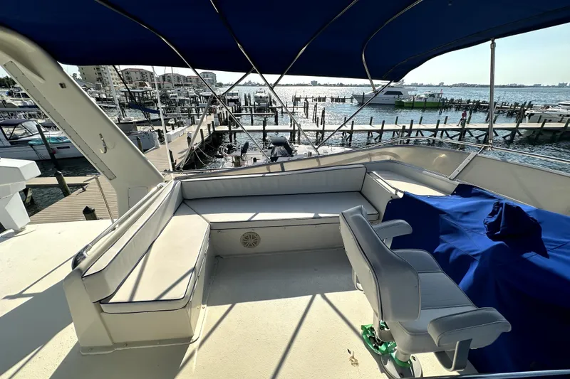 Slide: The Image of 1985 Chris-Craft 500 Constellation yacht deck with seating, overlooking marina and water. - 108