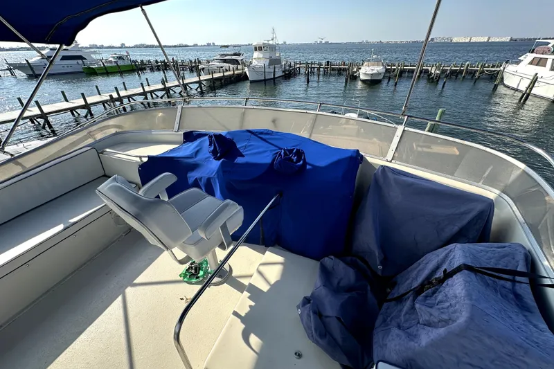 Slide: The Image of 1985 Chris-Craft 500 Constellation yacht deck with covered seating, overlooking marina. - 109