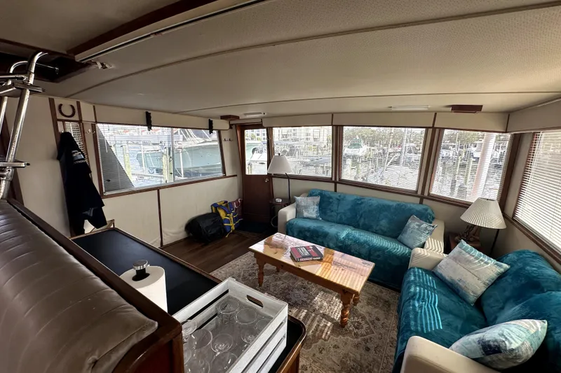 Slide: The Image of Interior of 1985 Chris-Craft 500 Constellation yacht with cozy seating and large windows. - 11