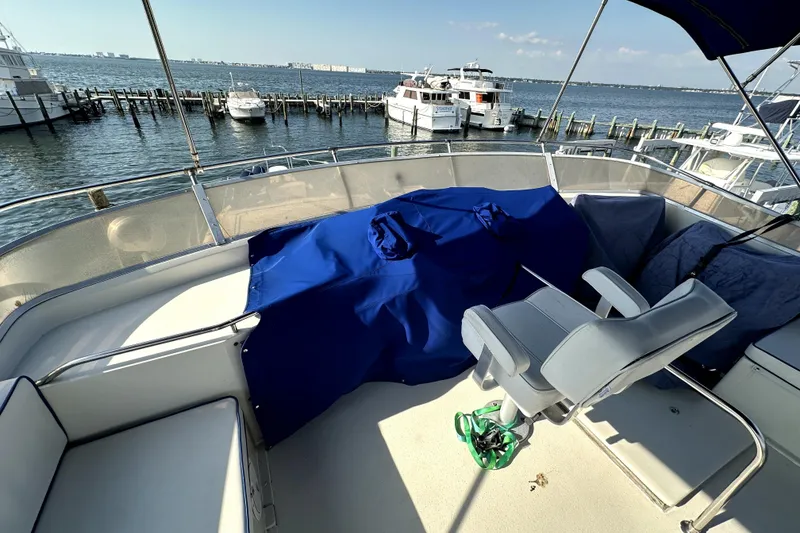 Slide: The Image of 1985 Chris-Craft 500 Constellation yacht deck with seating, overlooking marina and ocean. - 112