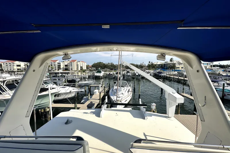 Slide: The Image of 1985 Chris-Craft 500 Constellation yacht docked at marina, view from deck under blue canopy. - 114