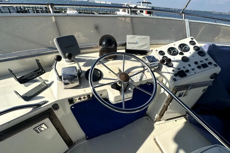 Slide: The Image of 1985 Chris-Craft 500 Constellation helm with Garmin navigation, steering wheel, and control panel. - 117