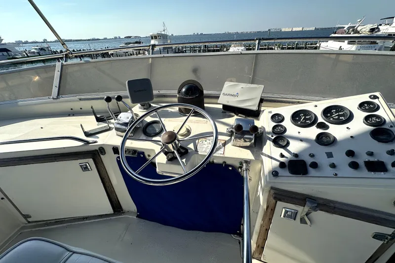Slide: The Image of 1985 Chris-Craft 500 Constellation helm with steering wheel, gauges, and Garmin navigation system. - 119