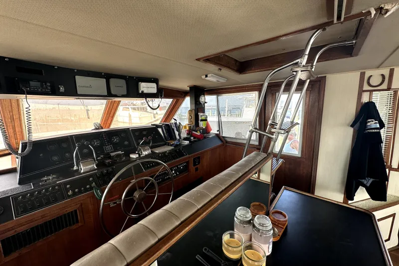 Slide: The Image of 1985 Chris-Craft 500 Constellation yacht interior with helm, steering wheel, and navigation equipment. - 12