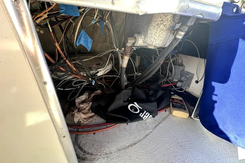 Slide: The Image of 1985 Chris-Craft 500 Constellation engine compartment with wiring and maintenance items. - 120