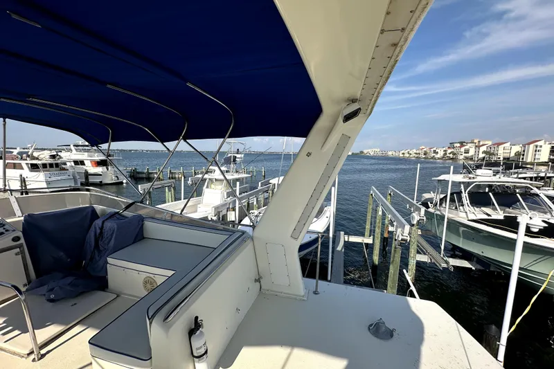 Slide: The Image of 1985 Chris-Craft 500 Constellation yacht docked at marina with blue canopy. - 125