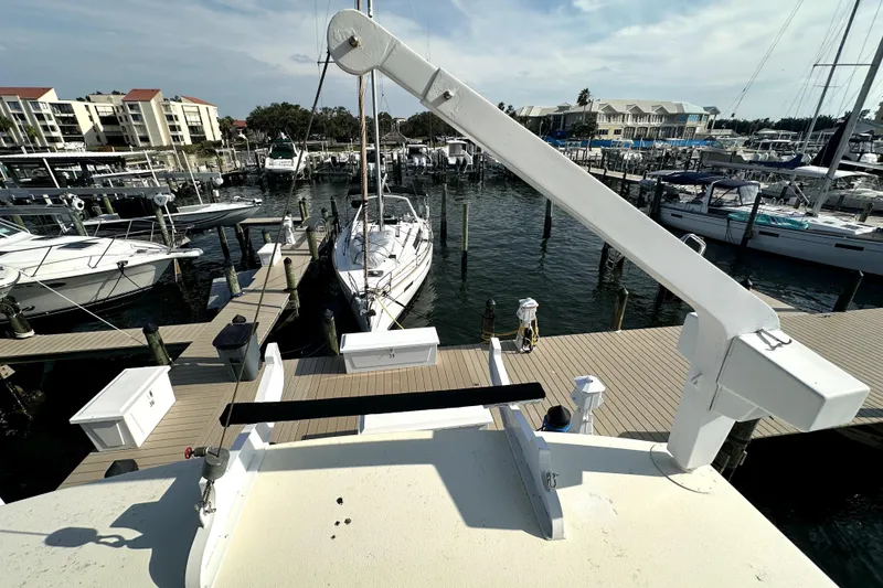 Slide: The Image of 1985 Chris-Craft 500 Constellation yacht docked at a marina with surrounding boats. - 126