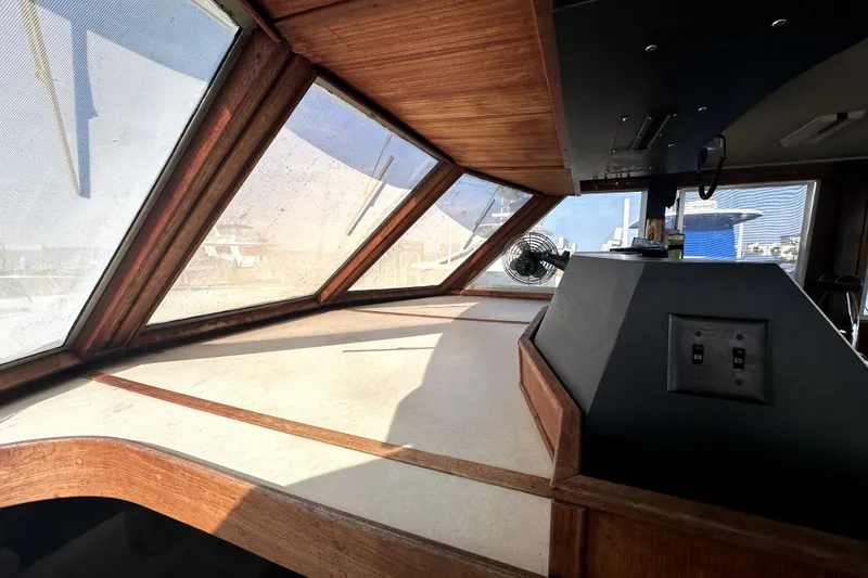 Slide: The Image of 1985 Chris-Craft 500 Constellation interior with wooden accents and large windows. - 13