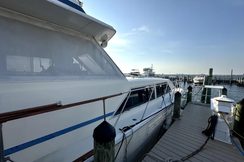 Slide: The Image of 1985 Chris-Craft 500 Constellation yacht docked at marina under clear blue sky. - 130