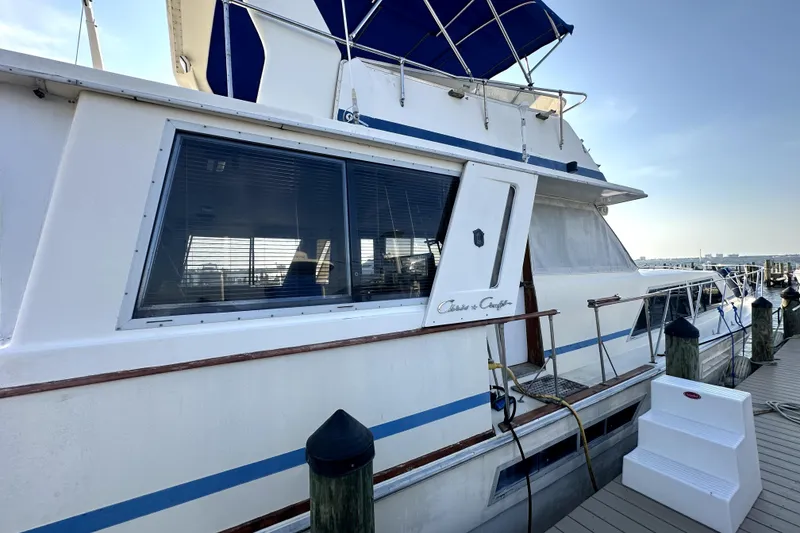 Slide: The Image of 1985 Chris-Craft 500 Constellation yacht docked, showcasing sleek design and classic elegance. - 131