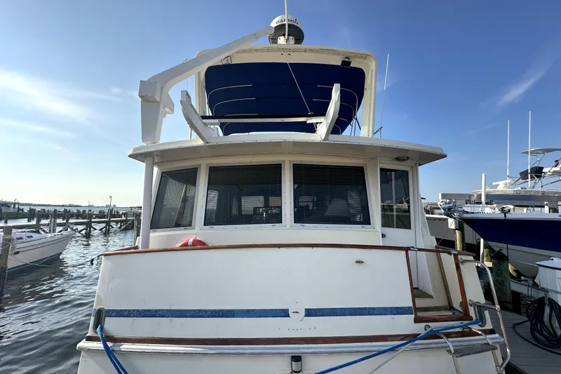 Slide: The Image of 1985 Chris-Craft 500 Constellation yacht docked at marina under clear blue sky. - 133