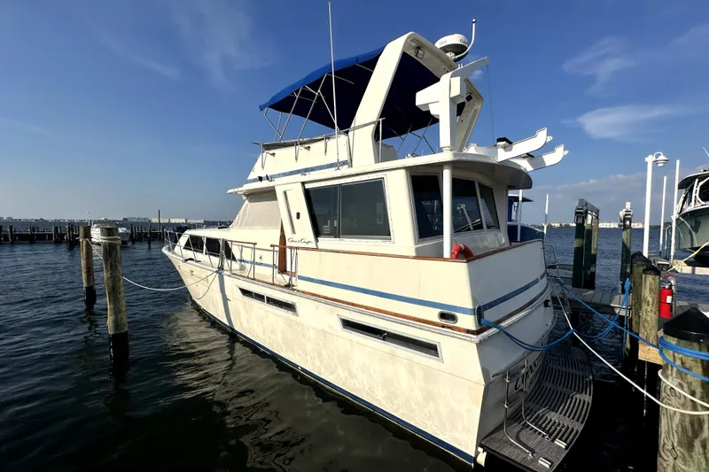 Slide: The Image of 1985 Chris-Craft 500 Constellation yacht docked at marina under clear blue sky. - 137