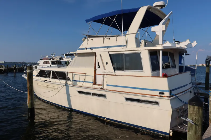 Slide: The Image of 1985 Chris-Craft 500 Constellation yacht docked at marina under clear blue sky. - 138