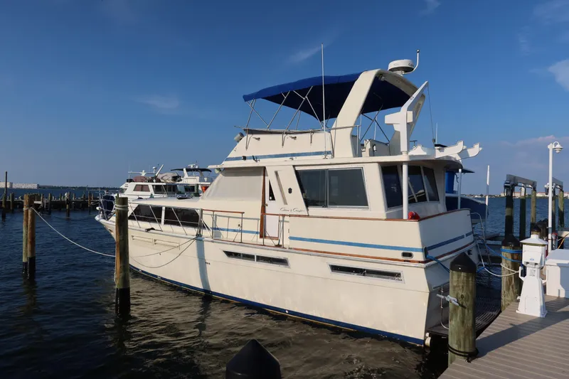 Slide: The Image of 1985 Chris-Craft 500 Constellation yacht docked at marina under clear blue sky. - 139