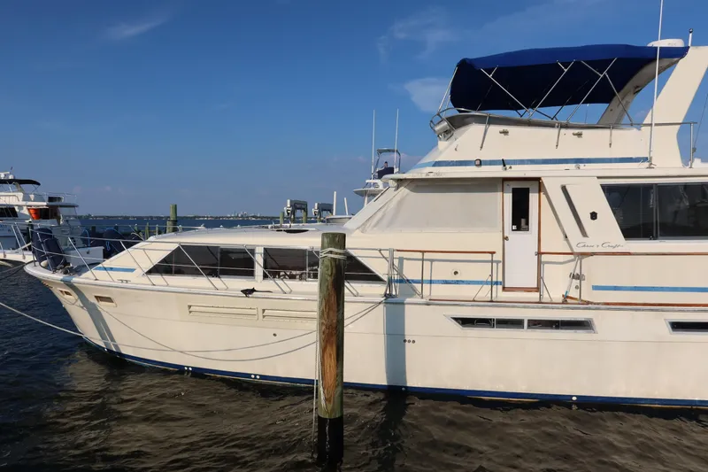 Slide: The Image of 1985 Chris-Craft 500 Constellation yacht docked under clear blue sky. - 143