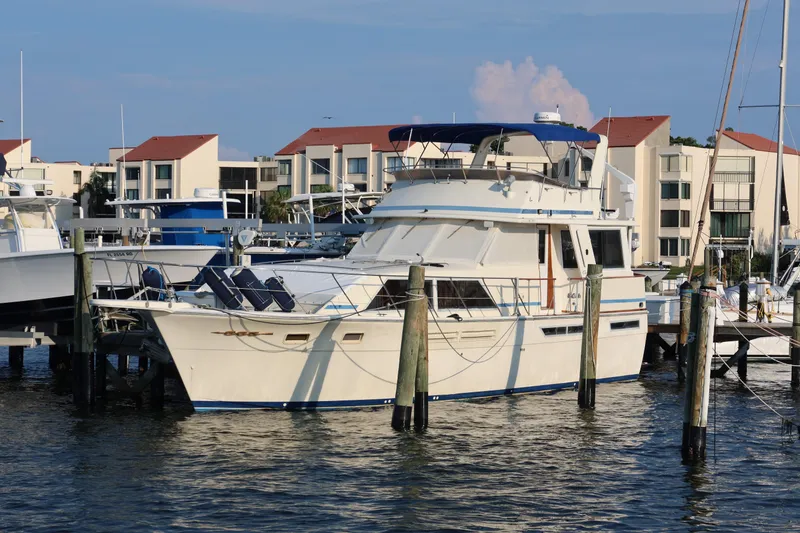Slide: The Image of 1985 Chris-Craft 500 Constellation yacht docked at marina with waterfront buildings. - 147