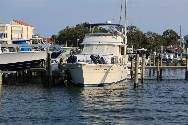 Slide: The Image of 1985 Chris-Craft 500 Constellation yacht docked at marina, surrounded by other boats. - 149