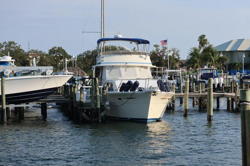 Slide: The Image of 1985 Chris-Craft 500 Constellation yacht docked at marina with American flag. - 151