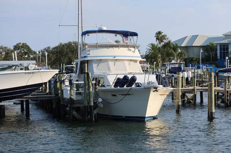 Slide: The Image of 1985 Chris-Craft 500 Constellation yacht docked at marina with clear sky. - 152