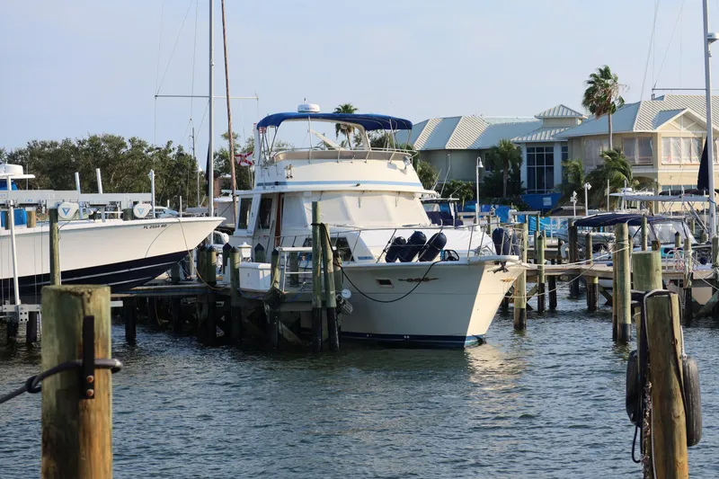 Slide: The Image of 1985 Chris-Craft 500 Constellation yacht docked at a marina with waterfront homes. - 153
