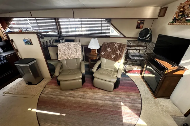Slide: The Image of Interior of 1985 Chris-Craft 500 Constellation with recliners, TV, and cozy decor. - 17