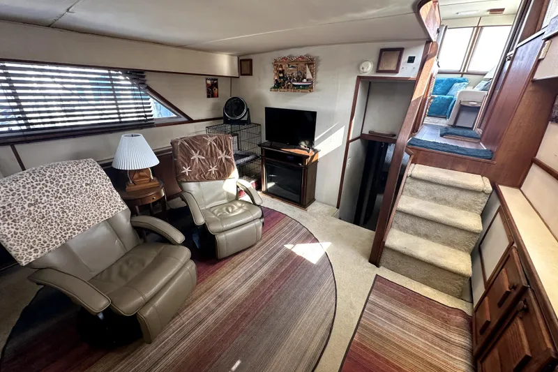 Slide: The Image of Interior of 1985 Chris-Craft 500 Constellation yacht with cozy seating and TV area. - 18