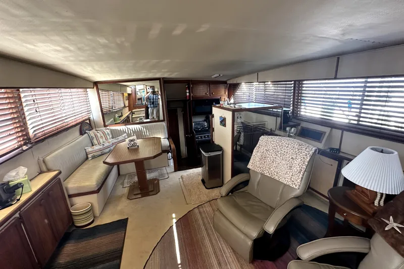 Slide: The Image of 1985 Chris-Craft 500 Constellation yacht interior with seating, table, and blinds. - 22