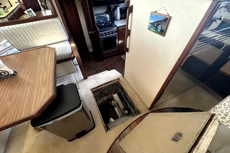 Slide: The Image of Interior of 1985 Chris-Craft 500 Constellation yacht with dining area and open hatch. - 24