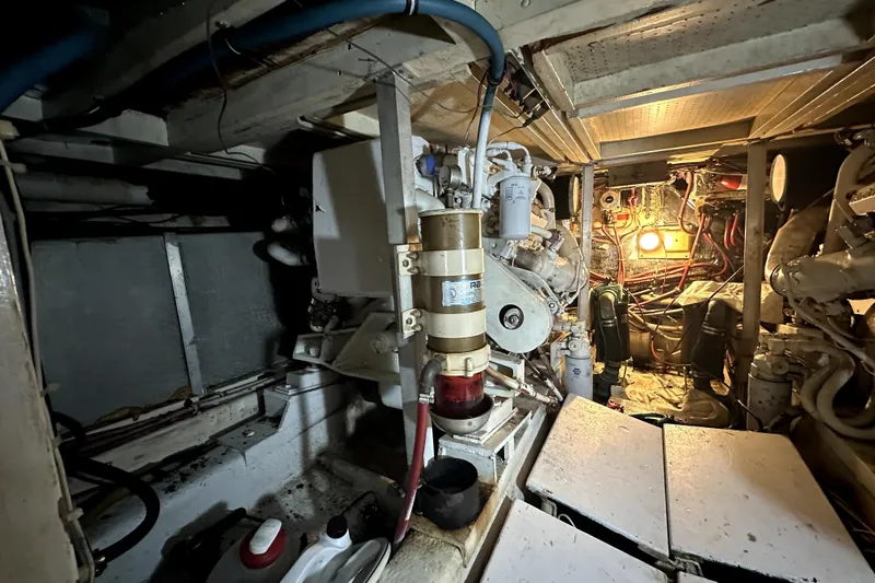 Slide: The Image of Engine room of 1985 Chris-Craft 500 Constellation yacht, showcasing mechanical components and wiring. - 27