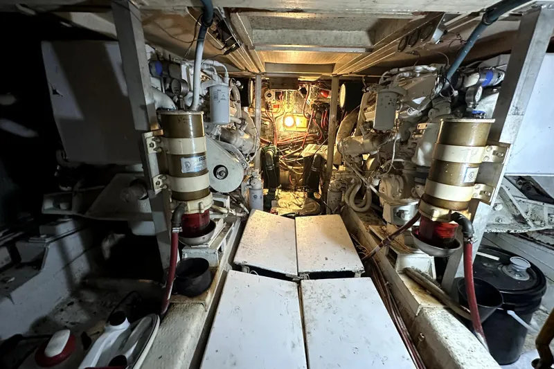 Slide: The Image of Engine room of 1985 Chris-Craft 500 Constellation yacht, showcasing mechanical components and lighting. - 28