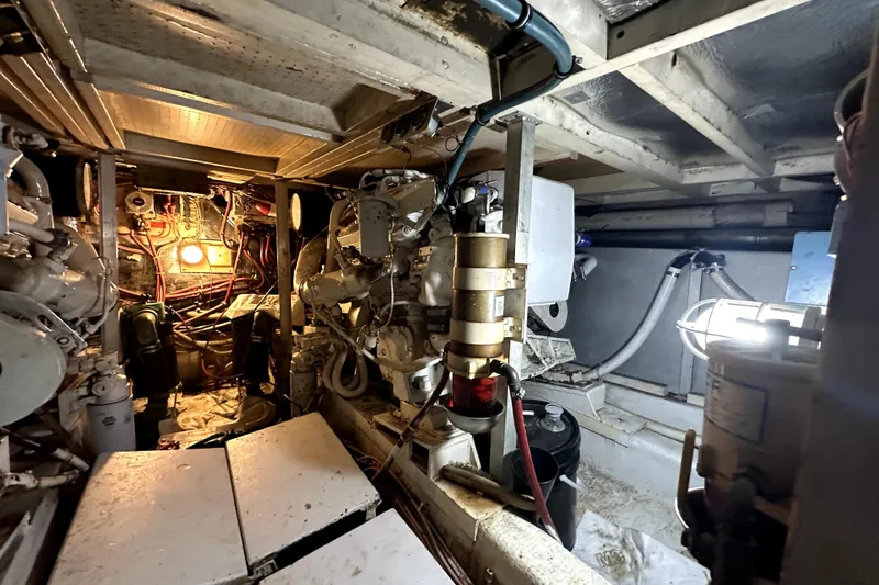 Slide: The Image of Engine room of 1985 Chris-Craft 500 Constellation yacht, showcasing mechanical components and wiring. - 29